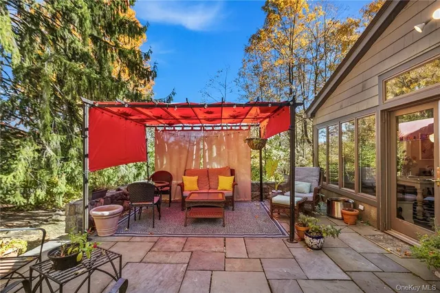 an outdoor sitting area with a table and chairs