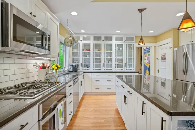 a kitchen with stainless steel appliances a stove a sink and a refrigerator