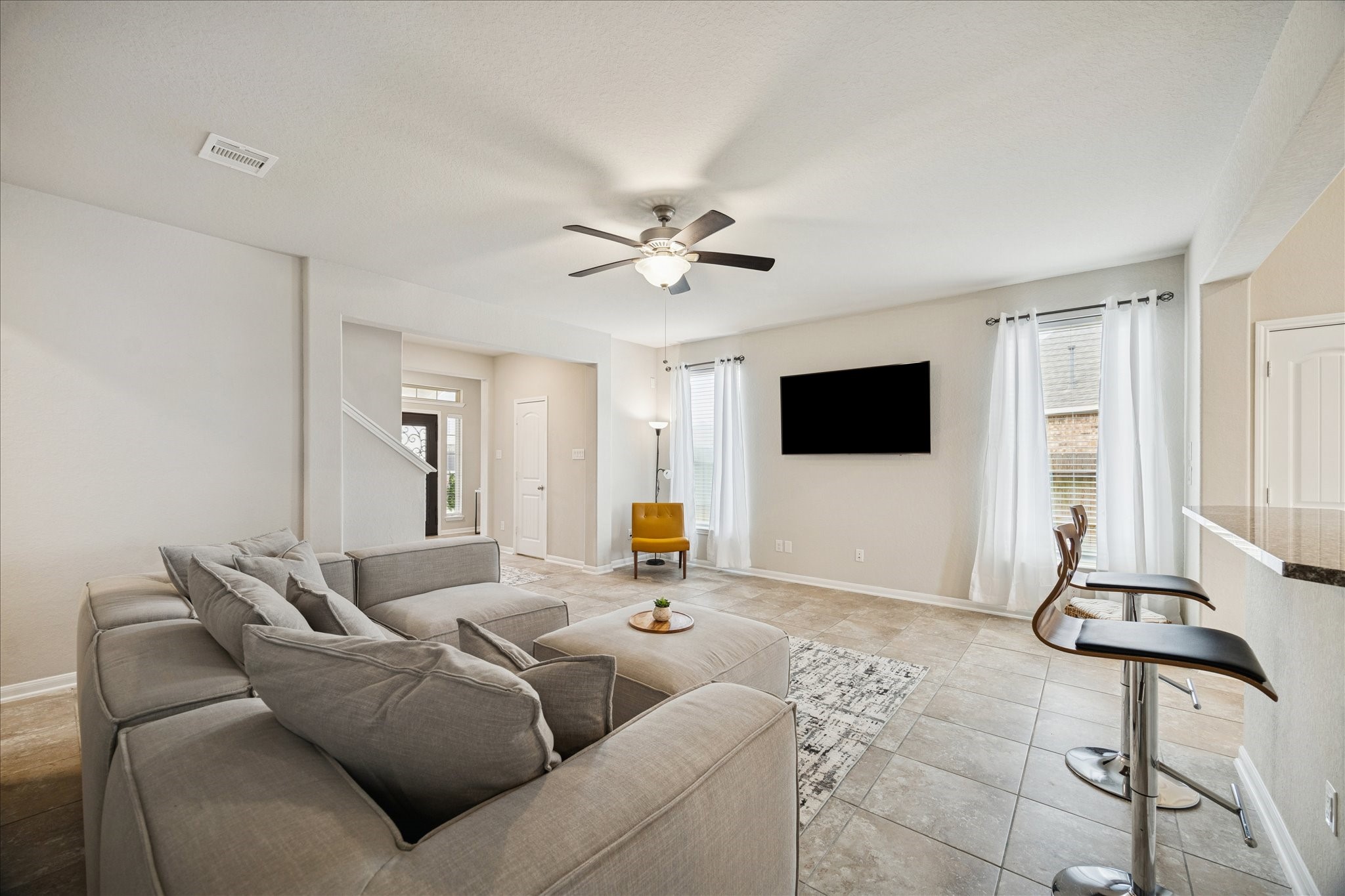 4411 Lone Alcove Drive Spring, TX 77386 - Photo 7 of 30 Breakfast bar seating creates the perfect spot to gather — easily turn toward the living room to stay connected while entertaining.
