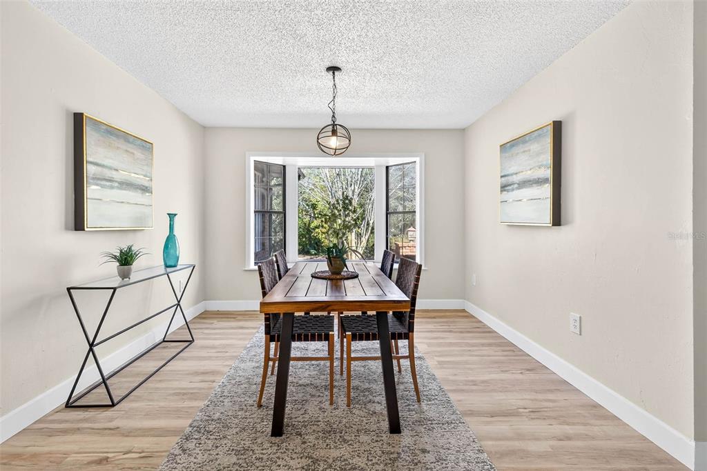 14252 Trinity Road Brooksville, FL 34614 - Photo 6 of 26 a view of a dining room with furniture window and wooden floor