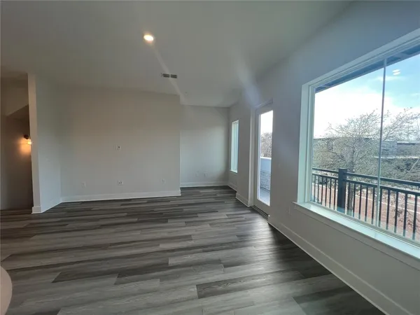 a large kitchen with stainless steel appliances granite countertop a stove and a wooden floors