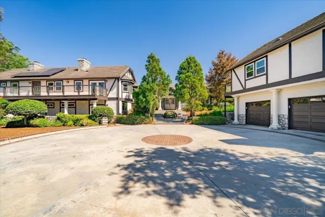a front view of a house with a yard and a garage
