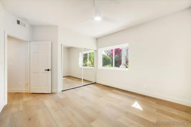 a kitchen with stainless steel appliances granite countertop a sink a stove and a white cabinets