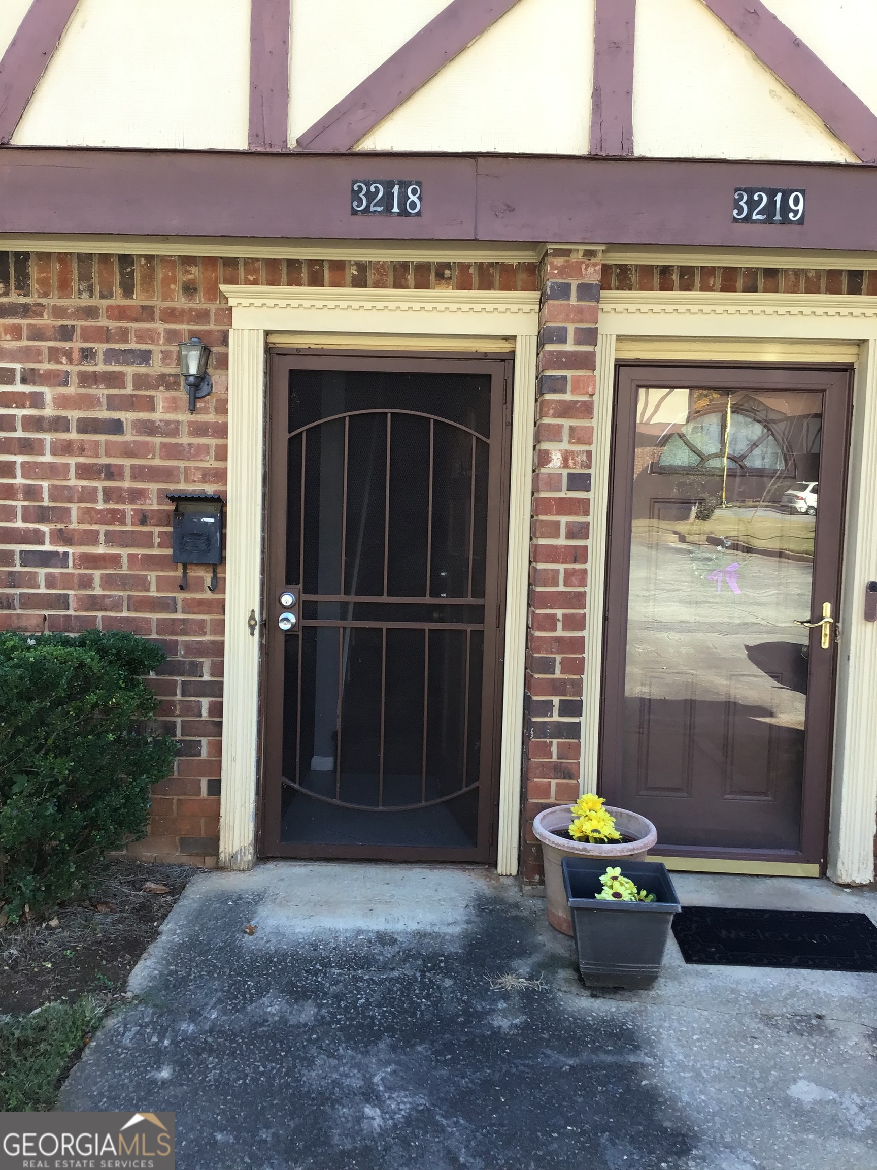 a front view of a building with table and chairs