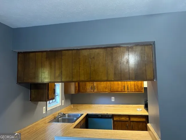 a kitchen with a sink and cabinets