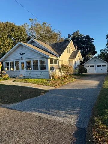 a front view of a house with a garden and yard