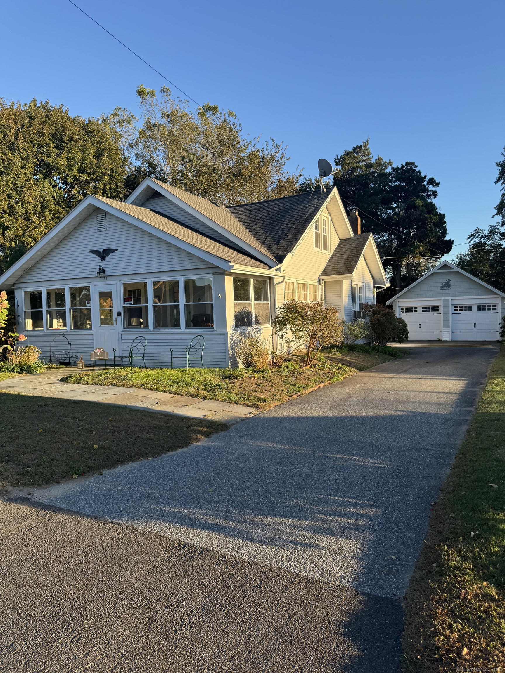 a front view of a house with a garden and yard