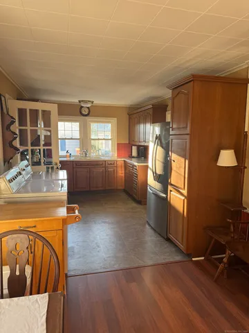 a kitchen with stainless steel appliances granite countertop a refrigerator a sink a stove and island