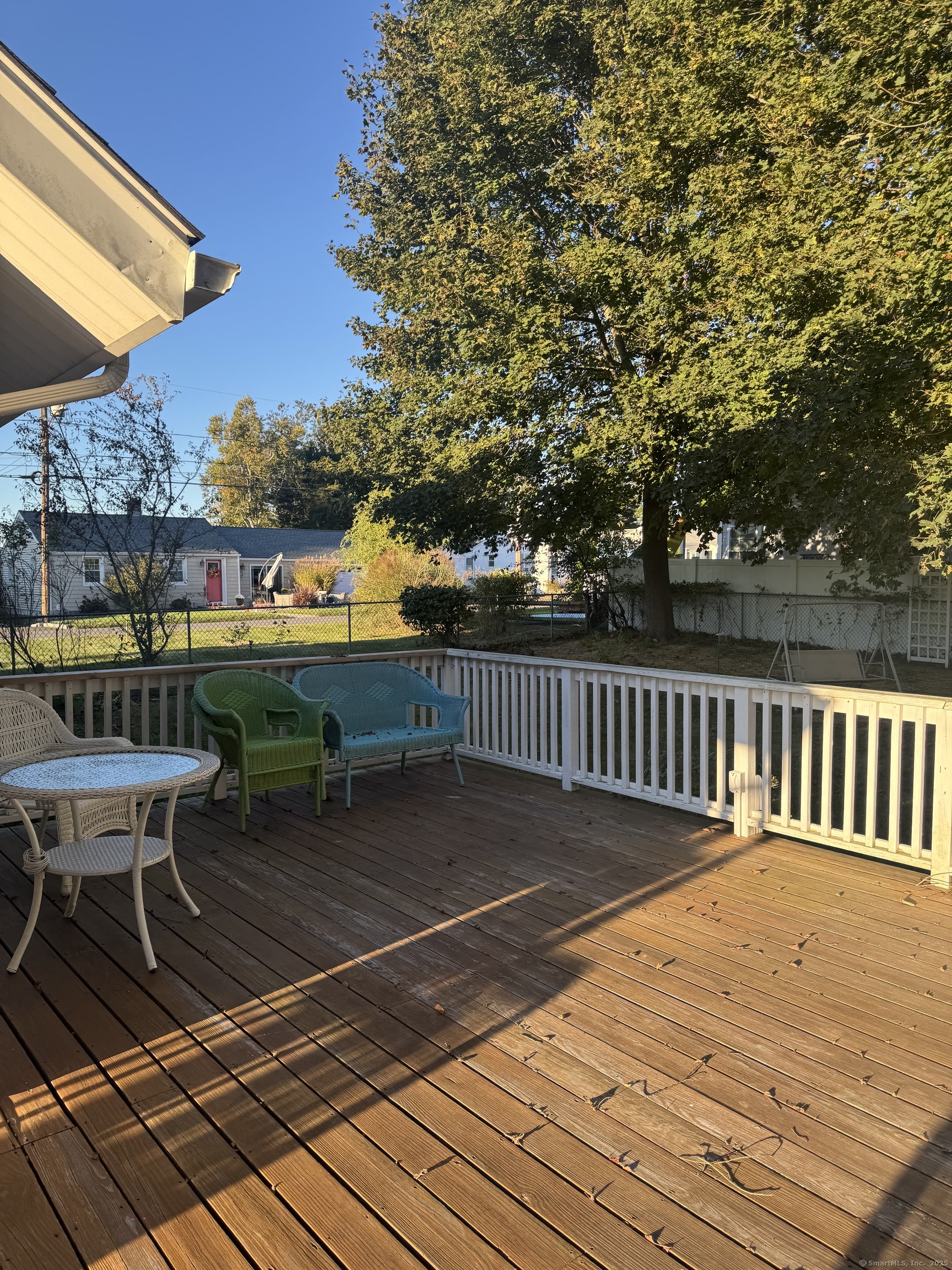 74 Uncas Road Clinton, CT 06413 - Photo 18 of 25 a balcony with wooden floor table and chairs