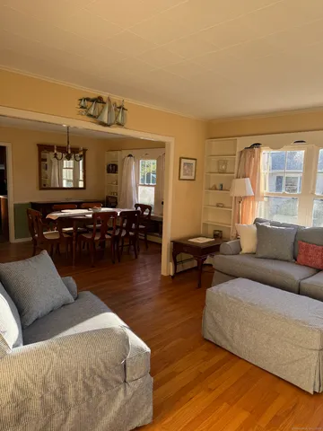 a living room with furniture window and wooden floor