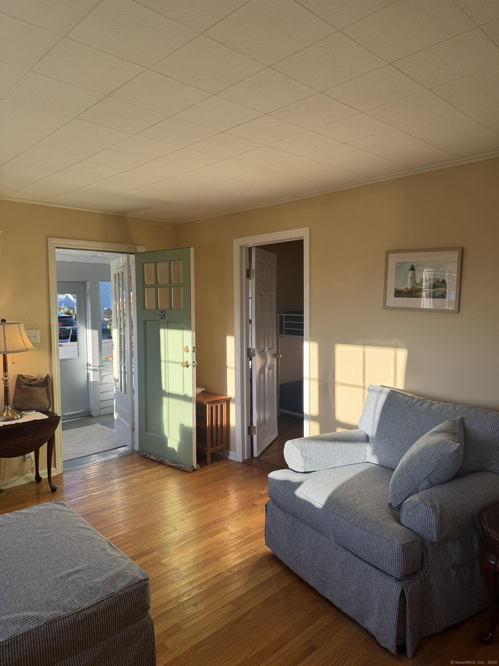 74 Uncas Road Clinton, CT 06413 - Photo 6 of 25 a living room with furniture and a wooden floor