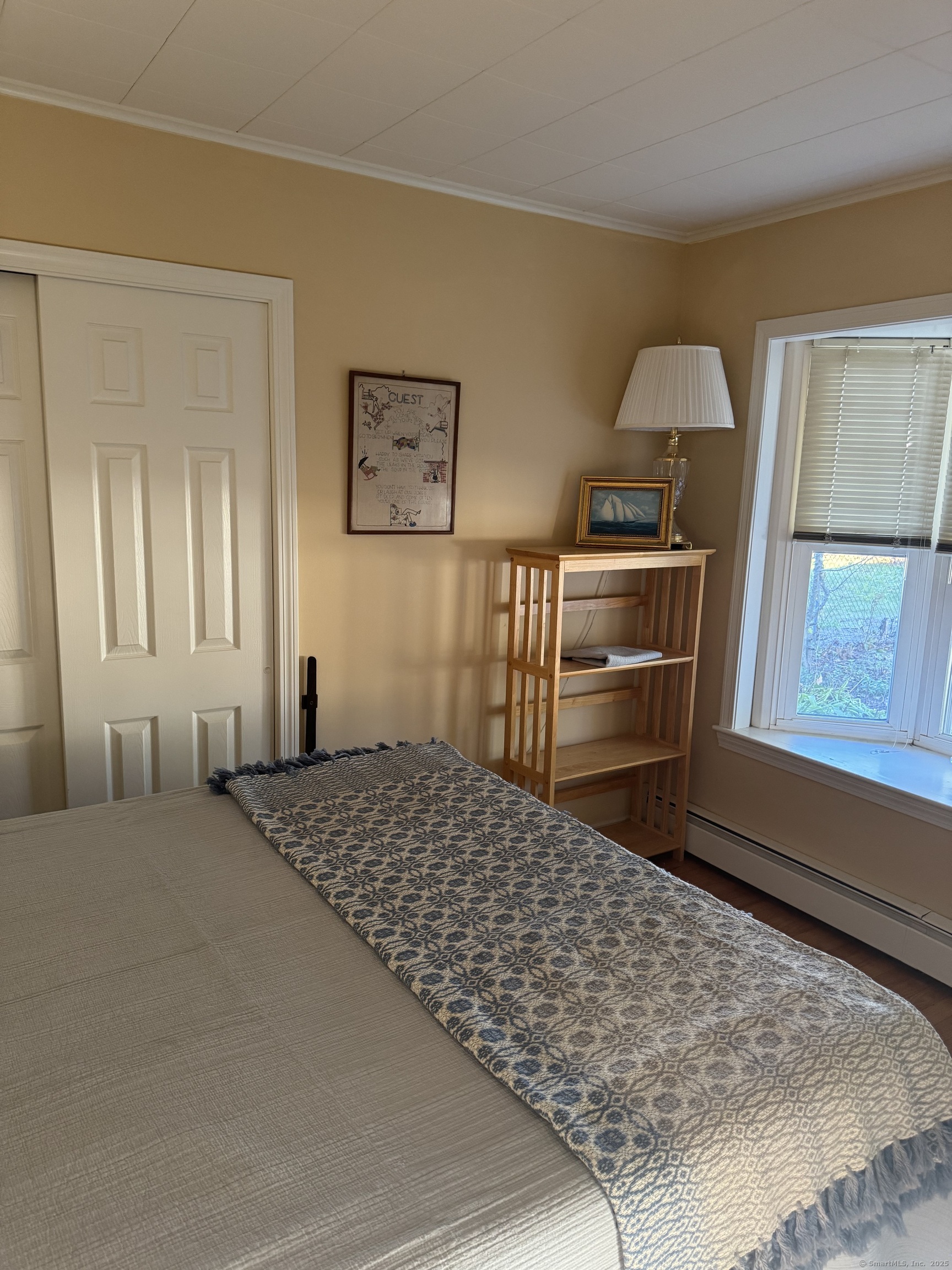 74 Uncas Road Clinton, CT 06413 - Photo 8 of 25 a bedroom with a bed and a dresser next to a window