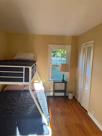 a room with wooden floor and windows