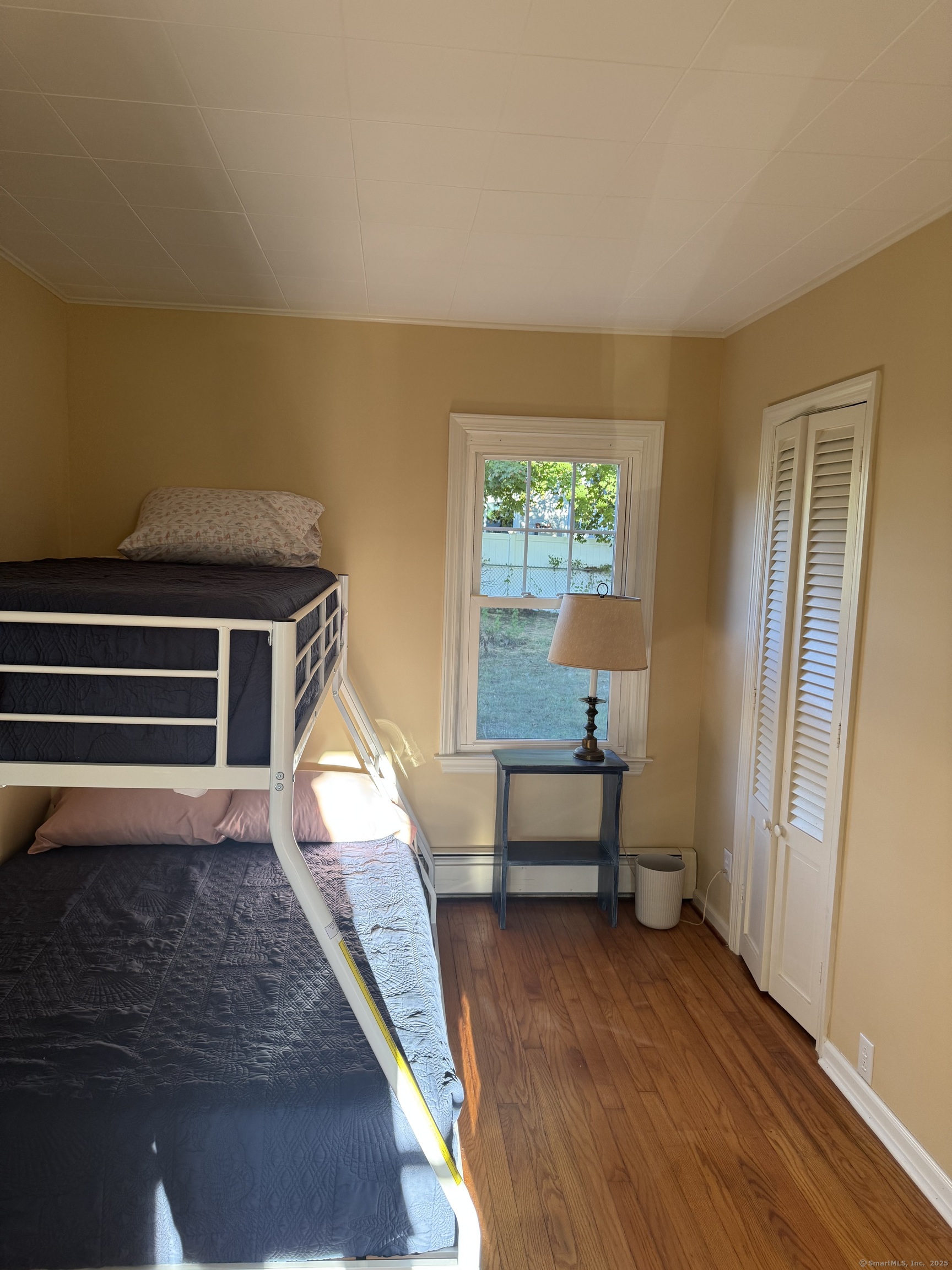 74 Uncas Road Clinton, CT 06413 - Photo 10 of 25 a room with wooden floor and windows