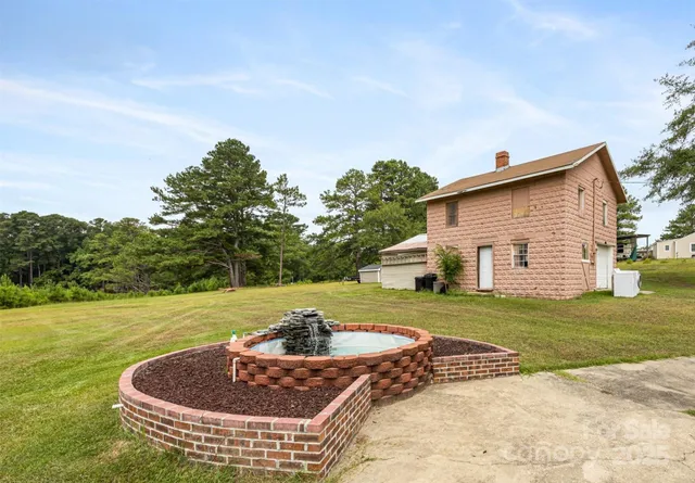 a view of a backyard with swimming pool