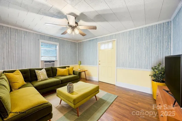 a living room with furniture and a flat screen tv