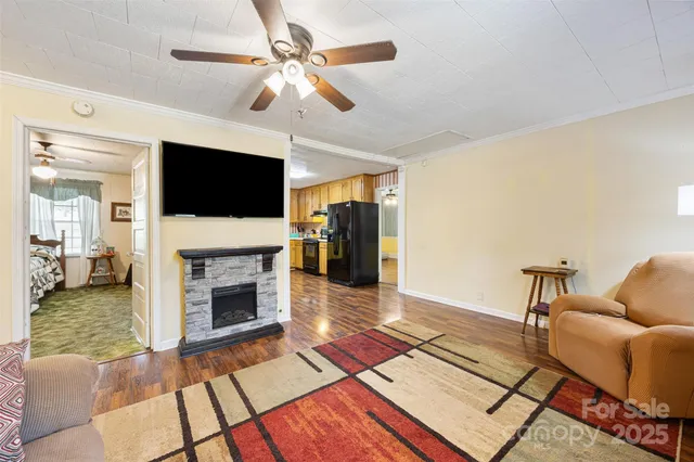 a living room with furniture a flat screen tv and a fireplace