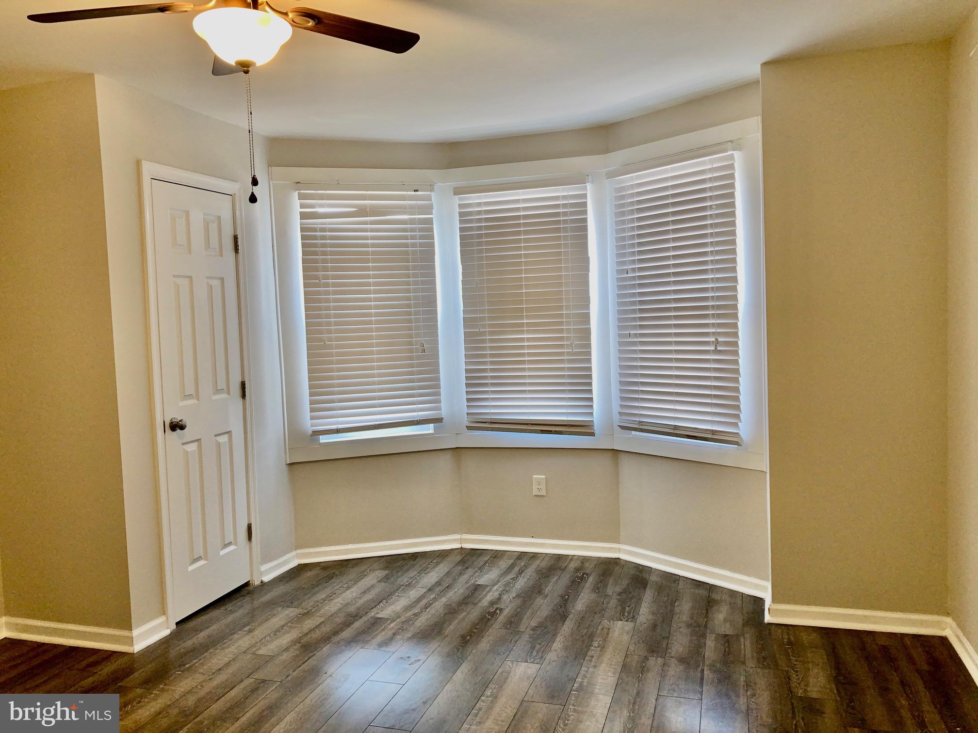 2647 South 12th Street Philadelphia, PA 19148 - Photo 10 of 19 a view of an empty room with wooden floor and a window