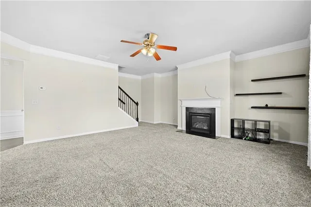 a view of an empty room with a fireplace and a window