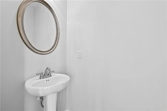 a view of an empty room with wooden floor and stairs