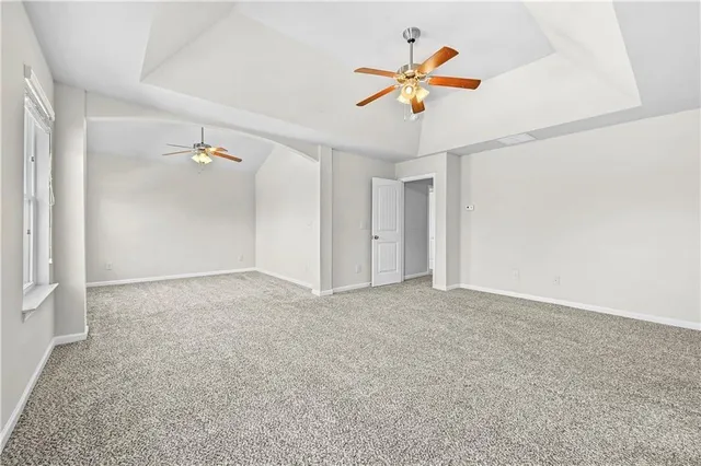 an empty room with fan and window