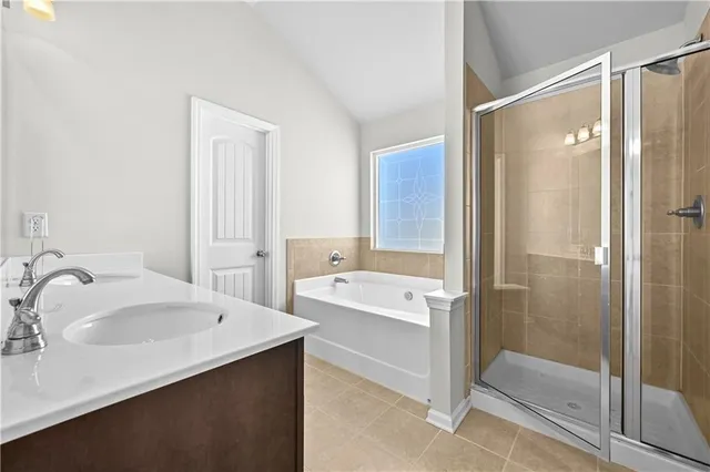 a bathroom with a tub sink and mirror