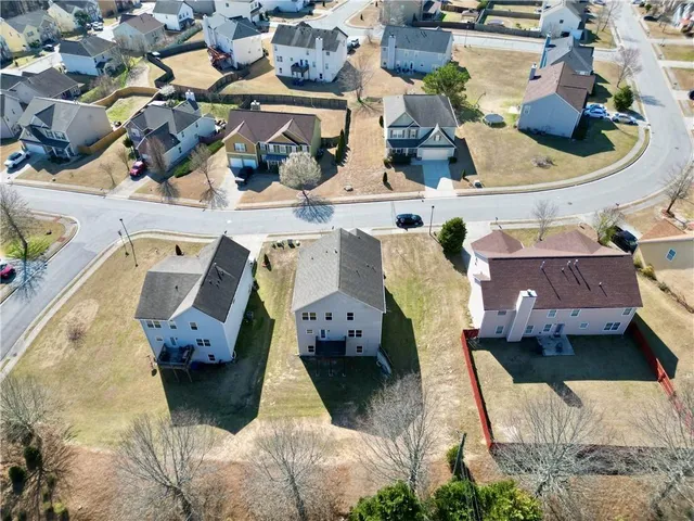 an aerial view of residential houses with outdoor space