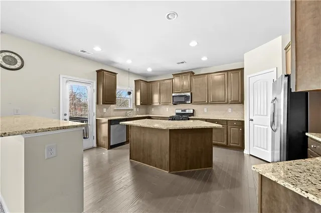 a kitchen with a sink stove and refrigerator