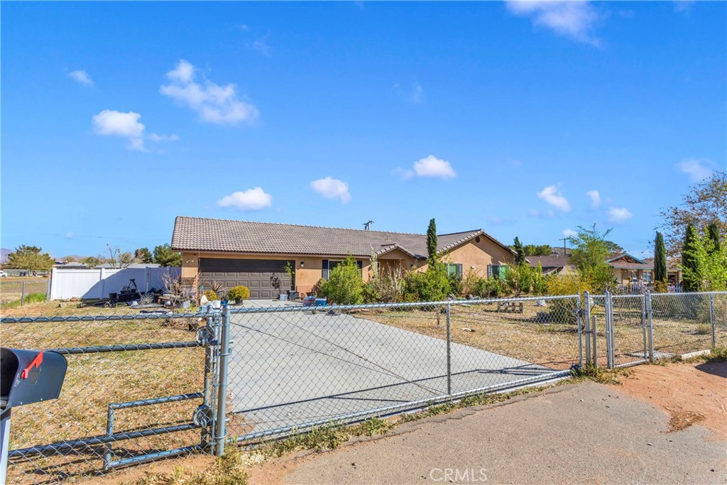 15565 Tonekai Road Apple Valley, CA 92307 - Photo 1 of 1 a view of a patio with a table and chairs