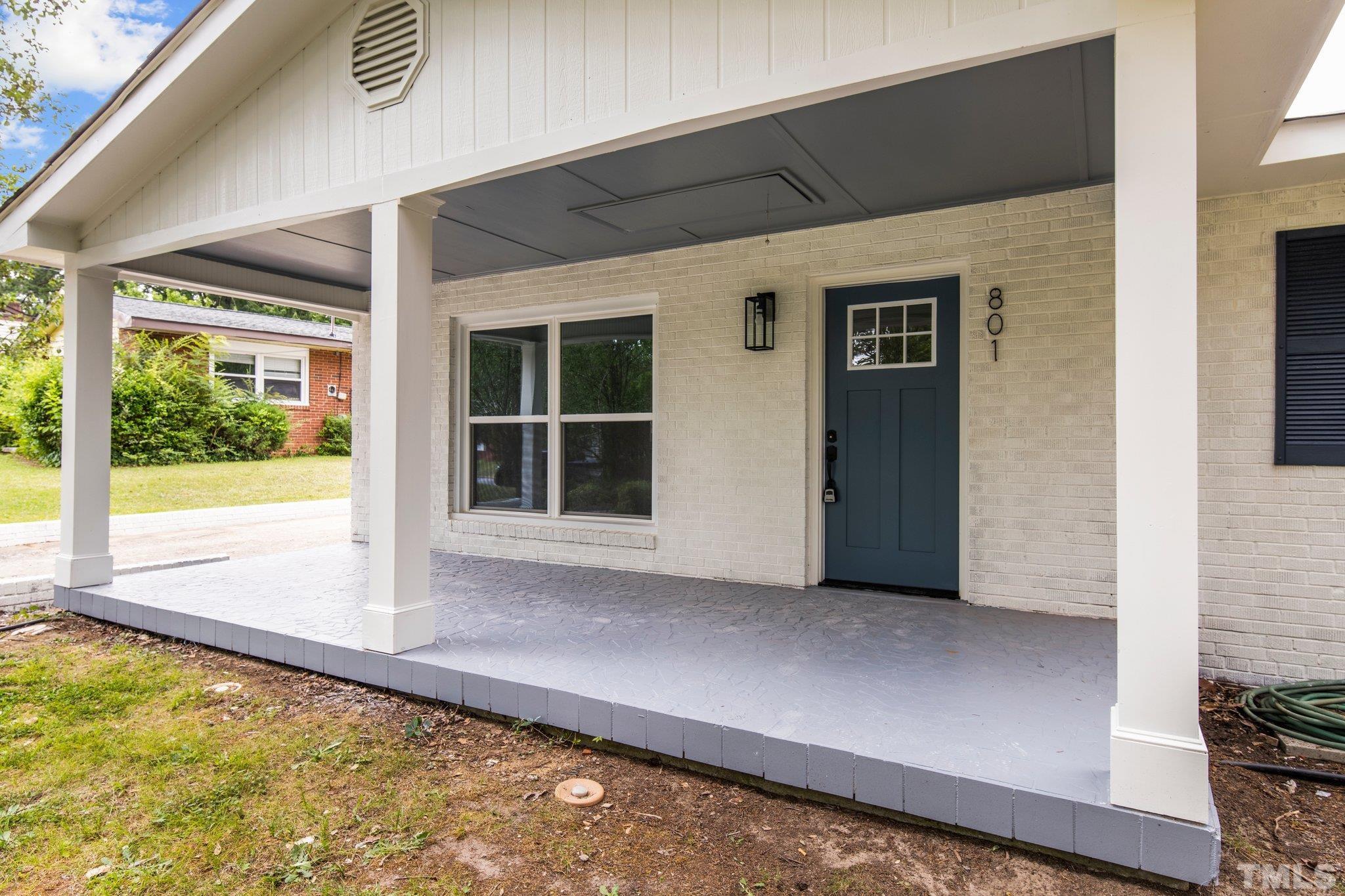 801 Friar Tuck Road Raleigh, NC 27610 - Photo 19 of 24 a view of a backyard with a large window and wooden floor