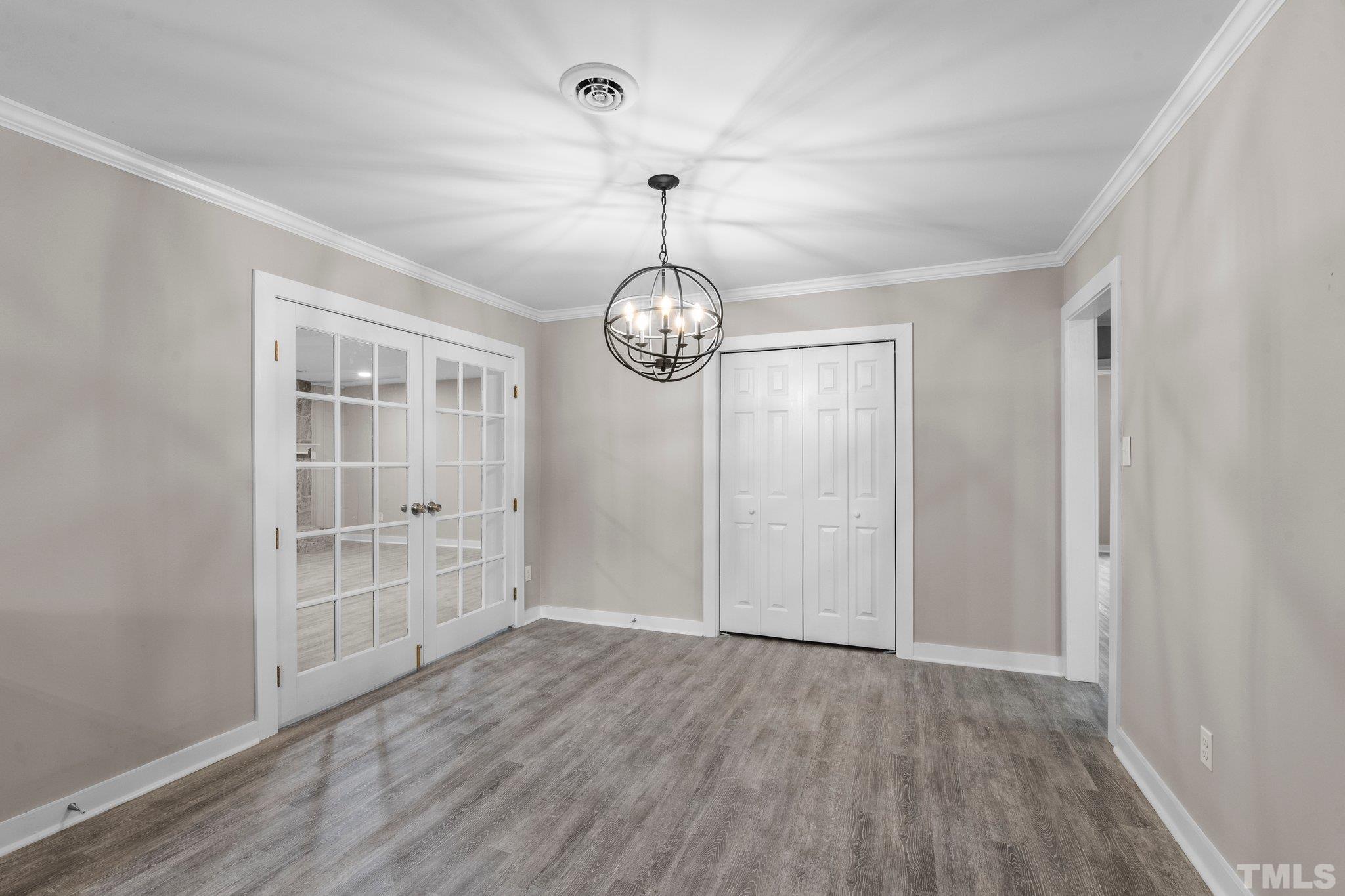 801 Friar Tuck Road Raleigh, NC 27610 - Photo 23 of 24 an empty room with wooden floor fan and windows