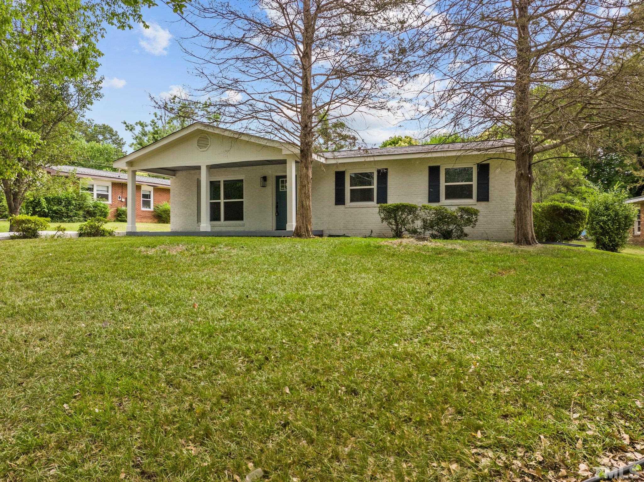 801 Friar Tuck Road Raleigh, NC 27610 - Photo 3 of 24 a front view of a house with a garden