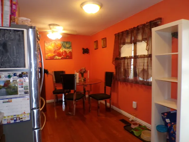 a view of living room with furniture and wooden floor