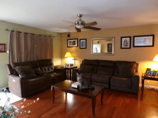 a living room with furniture and a wooden floor