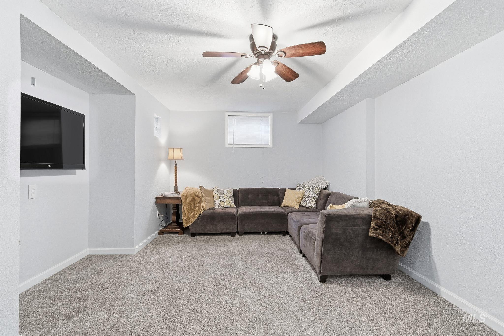 2103 West Bannock Street Boise, ID 83702 - Photo 22 of 49 Living area featuring light colored carpet and ceiling fan
