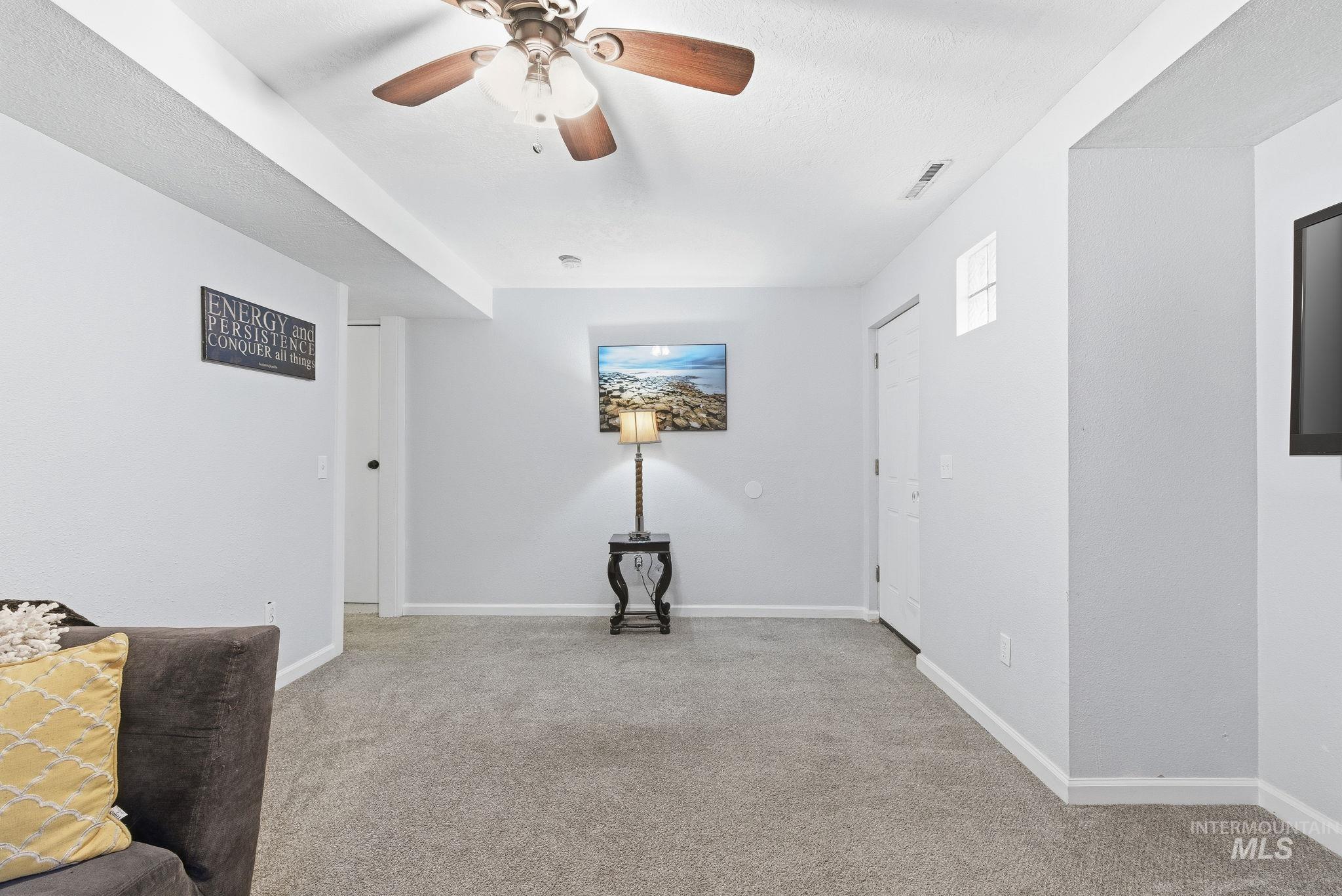 2103 West Bannock Street Boise, ID 83702 - Photo 23 of 49 Empty room with light colored carpet and a ceiling fan