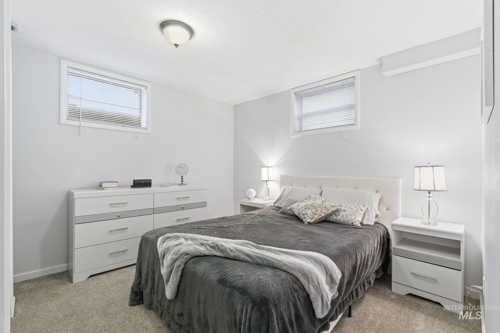 2103 West Bannock Street Boise, ID 83702 - Photo 24 of 49 Bedroom with light colored carpet and multiple windows