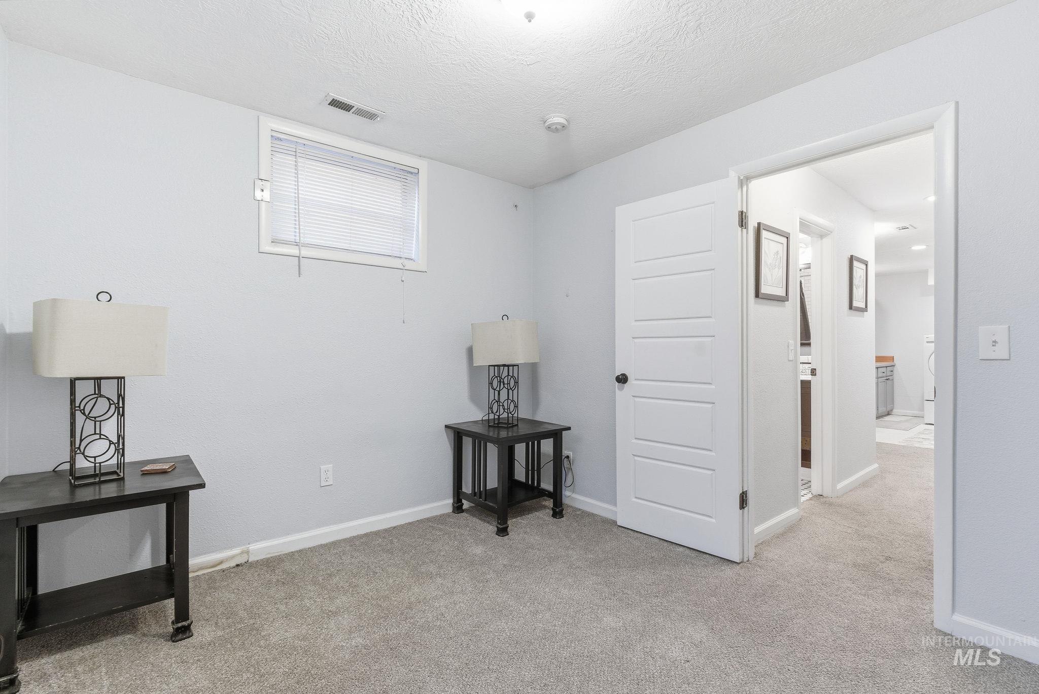 2103 West Bannock Street Boise, ID 83702 - Photo 28 of 49 Bedroom with light colored carpet and a textured ceiling