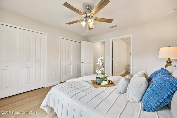 a bedroom with a bed and a chandelier