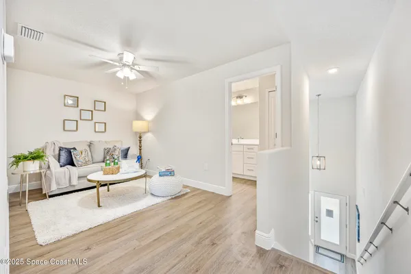 a living room with furniture and wooden floor
