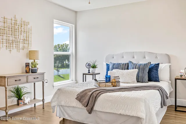 a bedroom with bed and a window