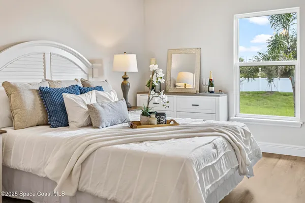 a bedroom with bed and window