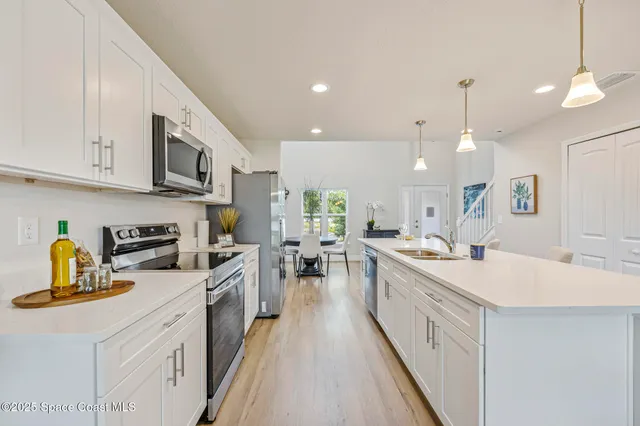 a kitchen with a sink stove and cabinets