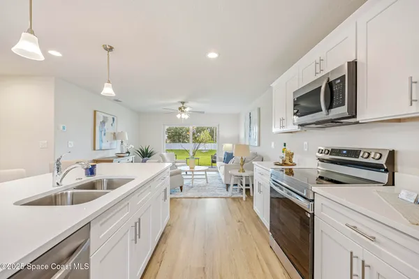 a kitchen with stainless steel appliances a stove sink microwave and cabinets