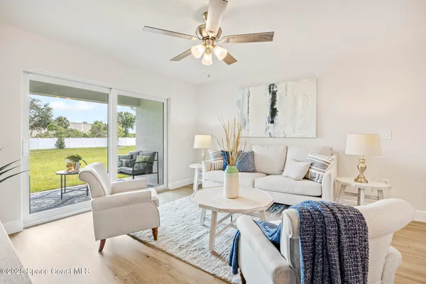 a living room with furniture and a large window
