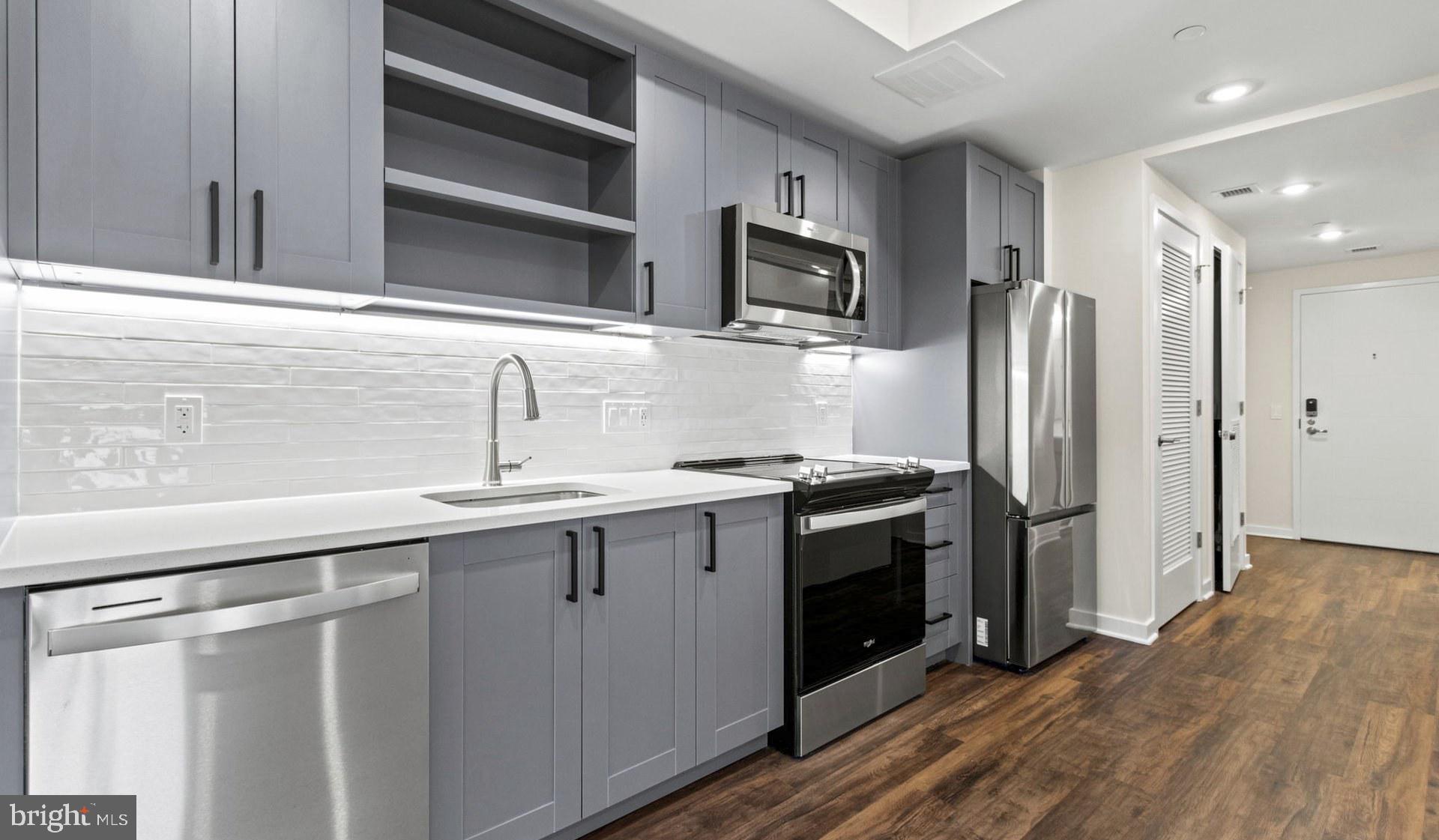 4000 Wisconsin Avenue Northwest, Unit 4K236 Washington, DC 20016 - Photo 50 of 54 a kitchen with stainless steel appliances a stove microwave and refrigerator
