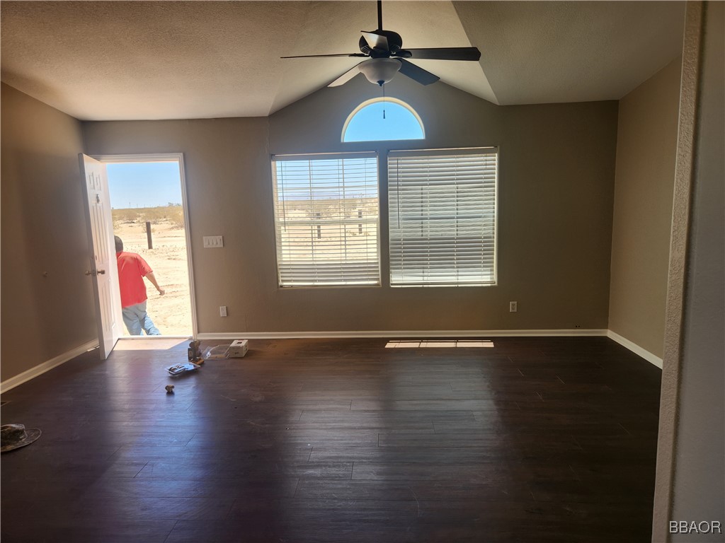 60824 Stagemans Road Landers, CA 92285 - Photo 5 of 6 an empty room with wooden floor and windows