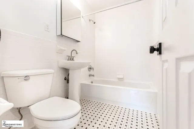 a bathroom with a toilet a sink and bathtub