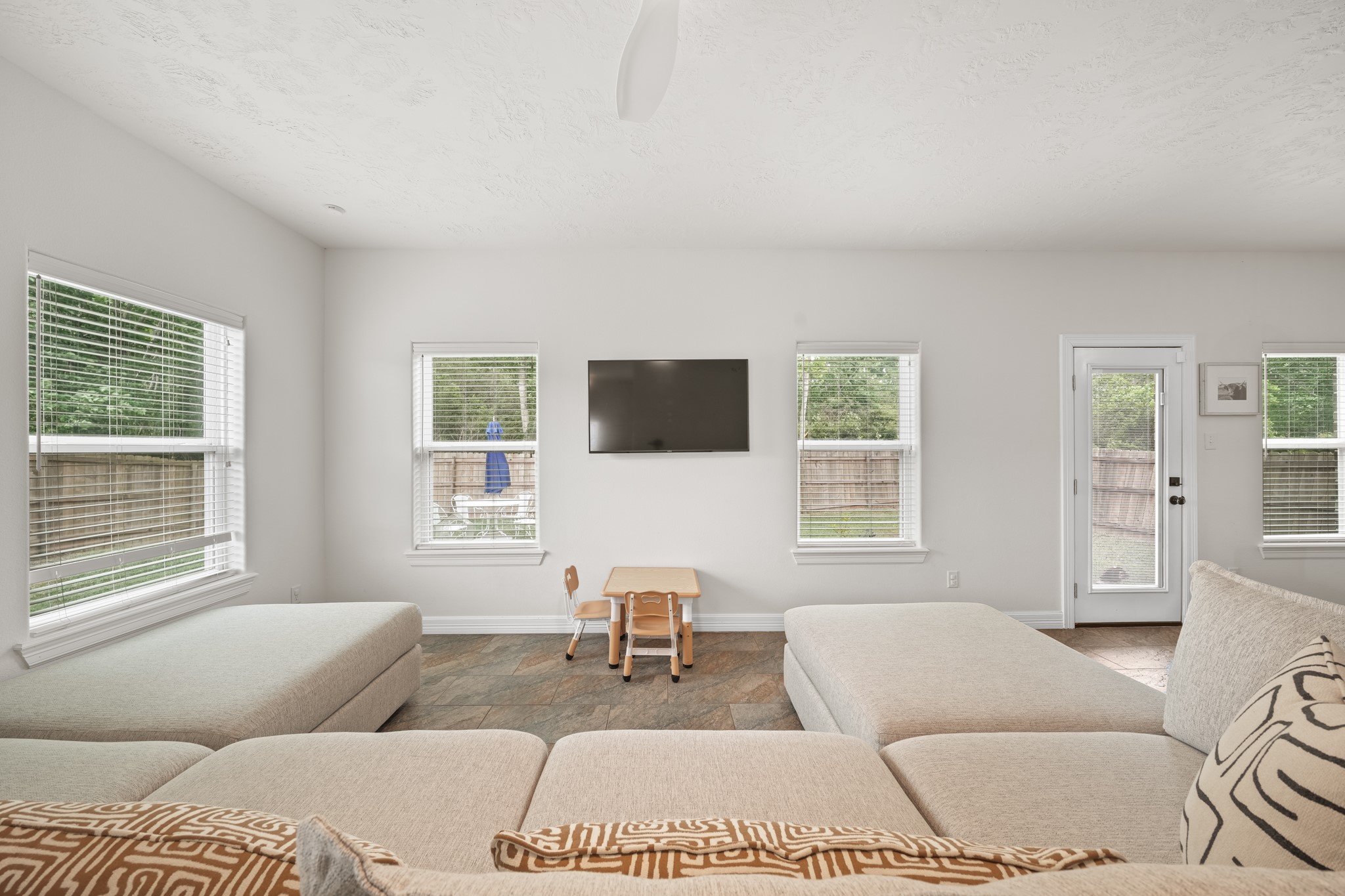 6101 Fox Ridge Drive Angleton, TX 77515 - Photo 10 of 30 a living room with furniture a flat screen tv and a window