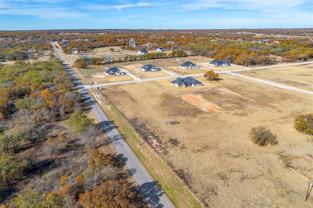 100 Prairie Winds Drive Poolville, TX 76487 - Photo 7 of 9 an aerial view of residential houses with outdoor space